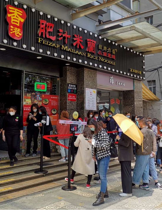 citizens wait eagerly outside of a restaurant in China that has recently re-opened after the coronavirus lockdown