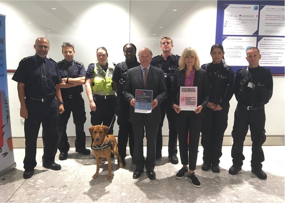borderforce officials and sniffer dog at heathrow airport