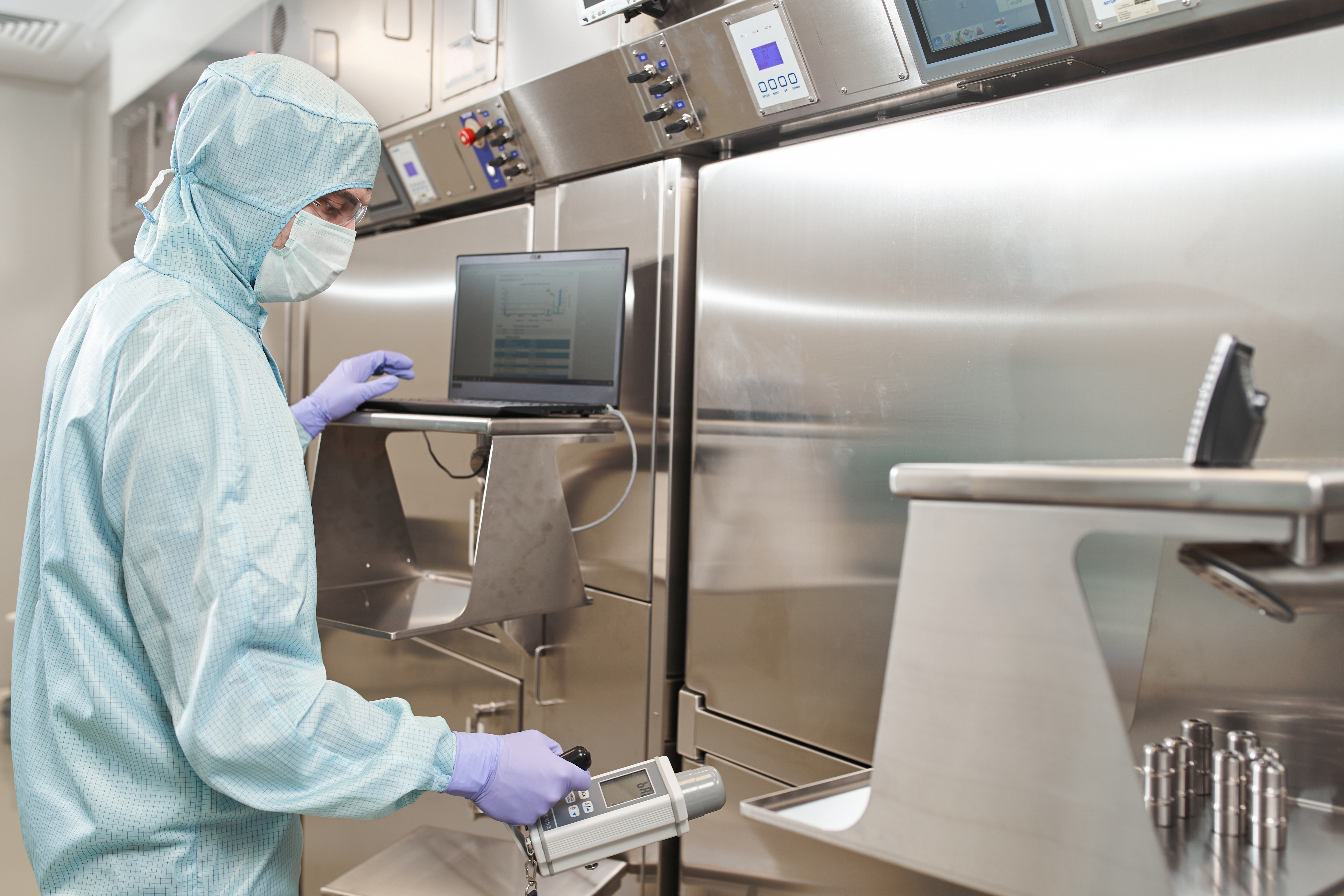 lab technician wearing full personal protective equipment completes vaccine research for a virus