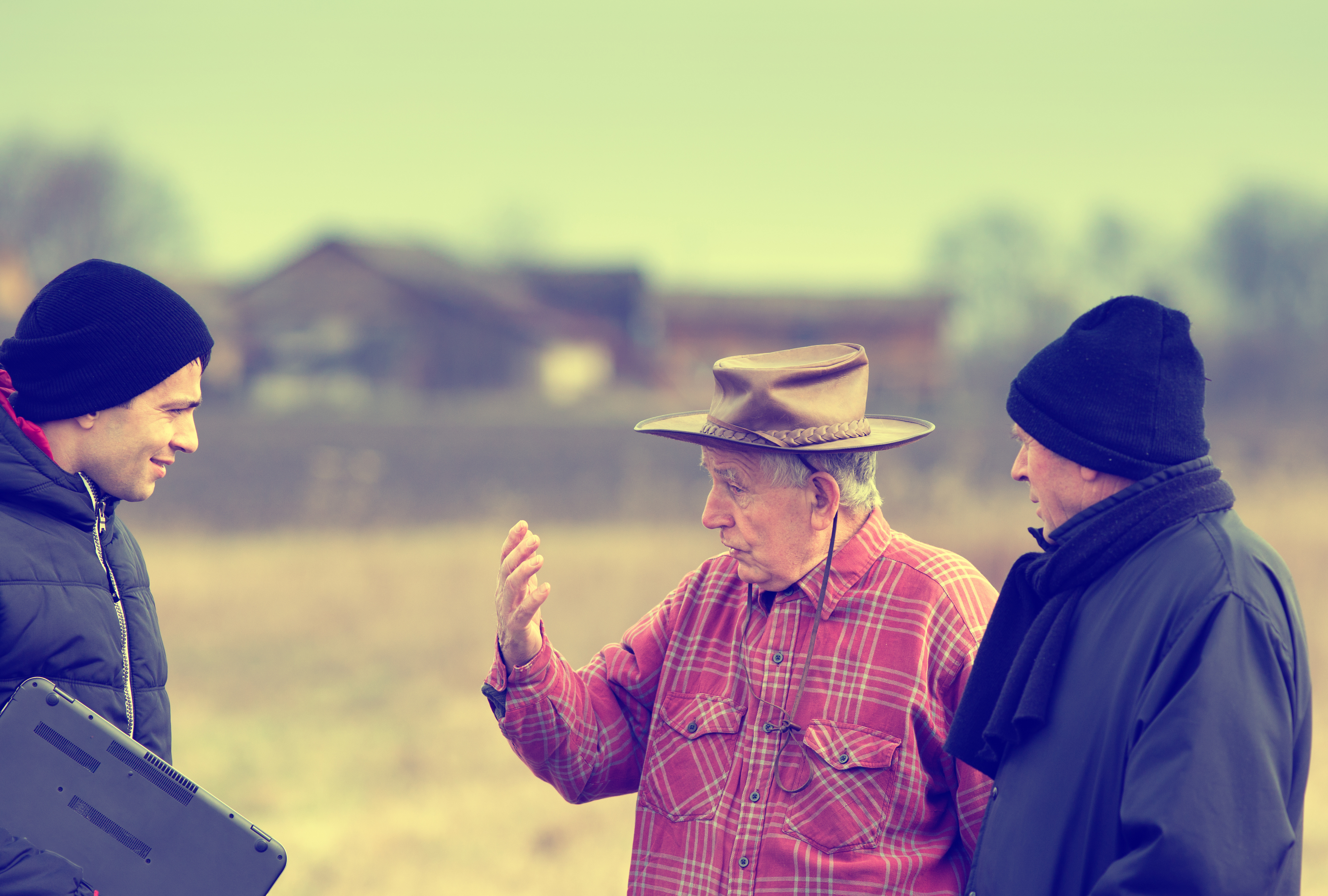 Farmer and regulators stand talking a field