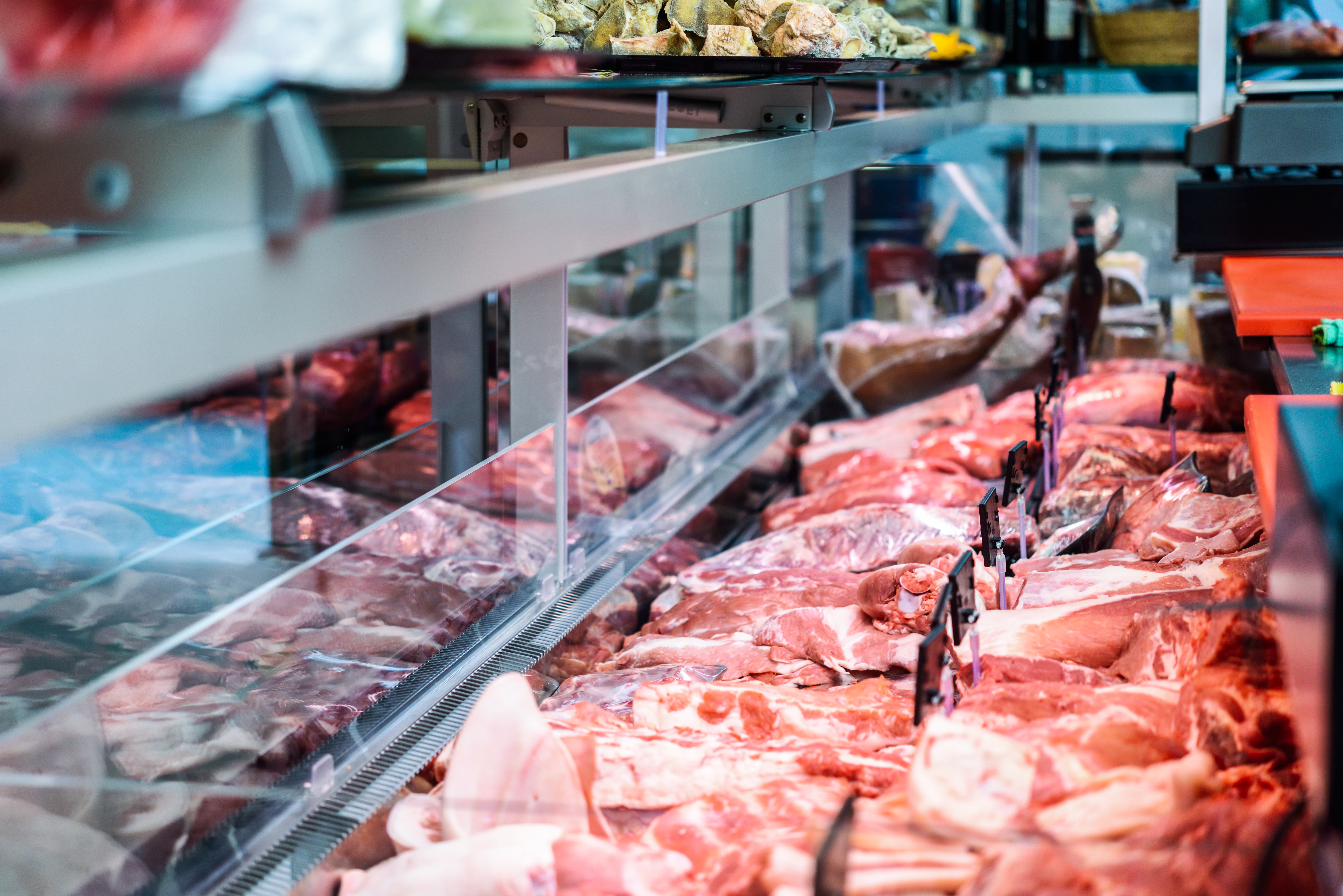 meat displayed in a refrigerator at a supermarket