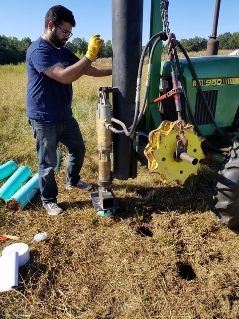 Jasmeet Lamba, assistant professor in the Auburn University College of Agriculture’s Department of Biosystems Engineering, takes soil samples from a field treated with poultry manure as a fertiliser source