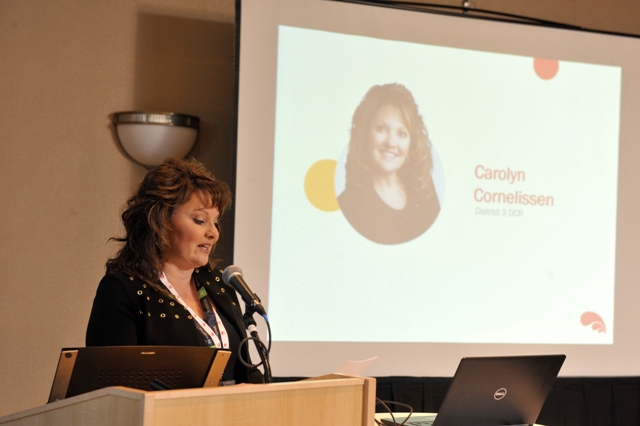 a woman gives a presentation from a podium