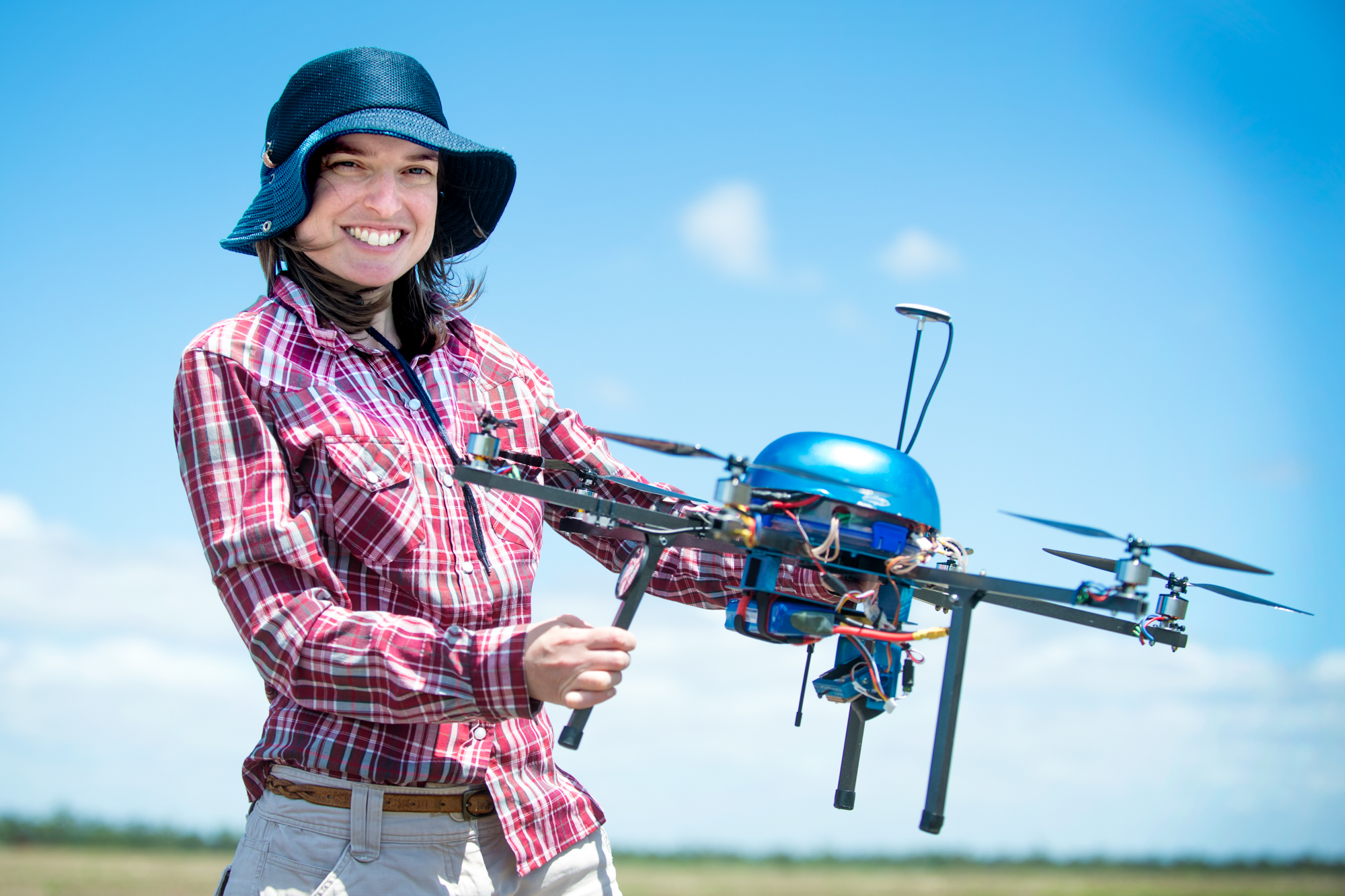 a woman holds a drone