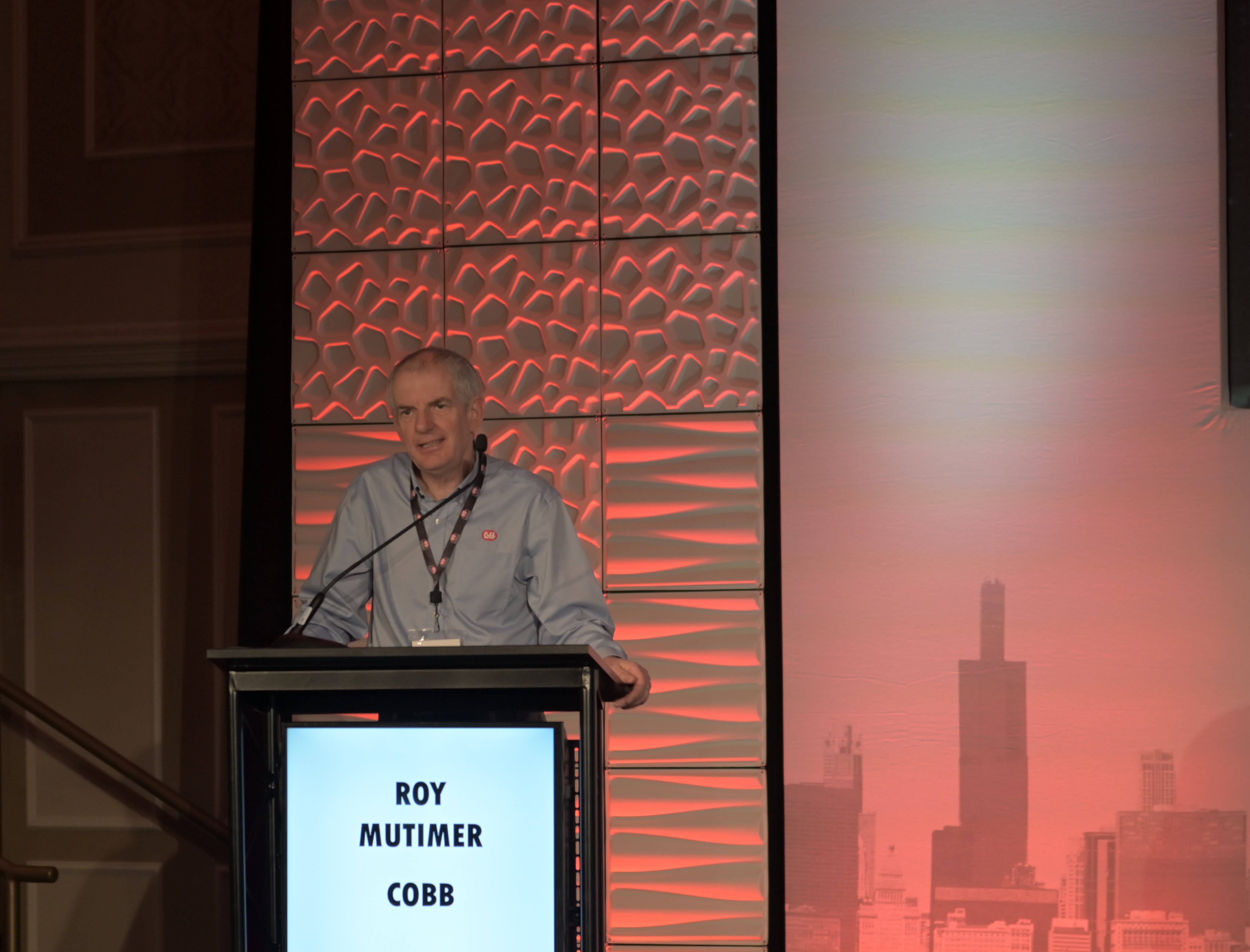 a man stands at a podium and speaks