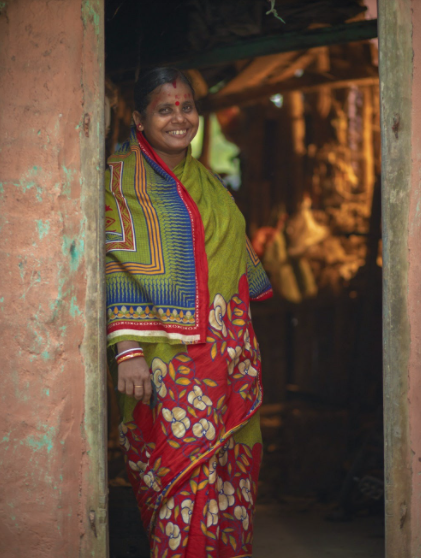 Geeta Rani Jena stands in the doorway of her home in Odisha, India.