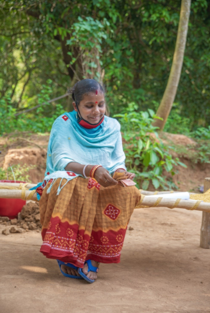 Geeta Rani Jena counts her earnings from a day's work.