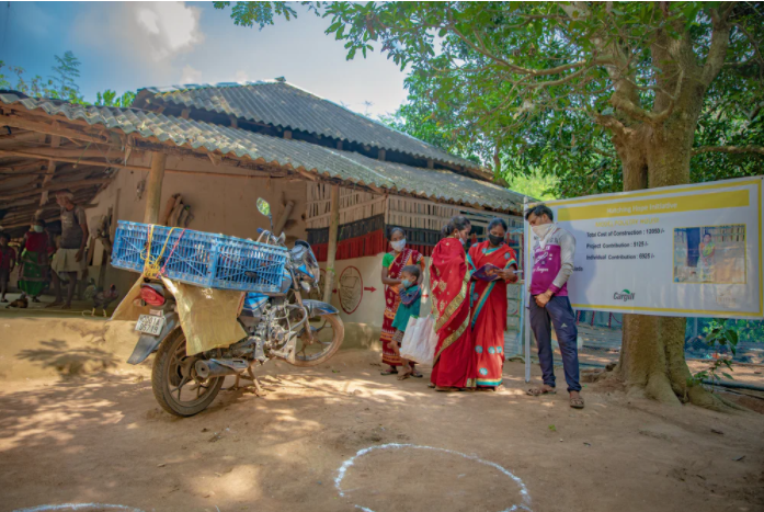 The compounding effects of the Covid-19 pandemic have severely impact rural communities. Here in Odisha, India, the community has gathered to sell their chickens to a vendor who travels to remote areas by motorcycle.