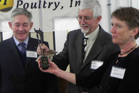 Thijs Hendrix, President of Hendrix Genetics (left) congratulates Gijs Schimmel (center), President of Centurion Poultry and Louise Schimmel (right)