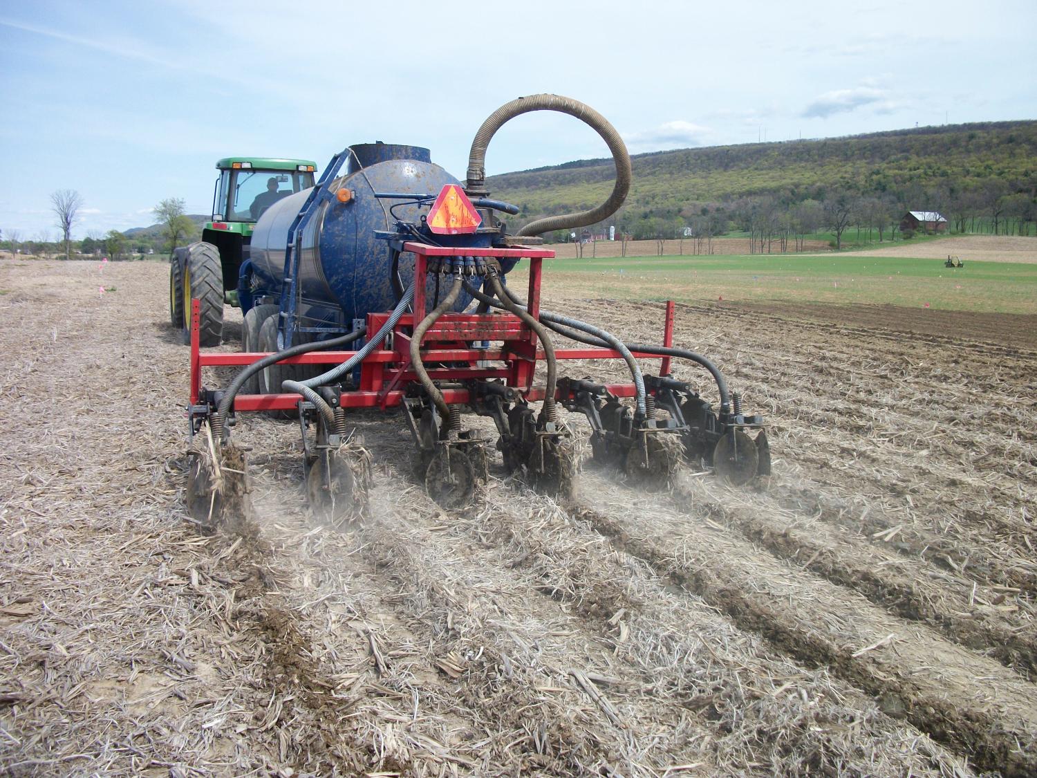 Dairy farms — especially in the Northeast — are increasingly subject to more stringent regulations to reduce nutrient losses. With expected warmer conditions that will result in increased ammonia volatilization from manure and more frequent and more severe storms that will cause more soluble phosphorus runoff, new strategies such as manure injection (shown) are needed to limit nitrogen and phosphorus losses from crop fields. Credit: Robert Meinen. All Rights Reserved.